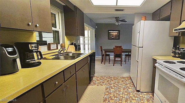 2119 Pellam Blvd, Port Charlotte, FL 33948 - kitchen featuring white appliances, light countertops, a ceiling fan, dark brown cabinetry, and light floors