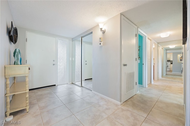 4549 SE 5th Pl Unit 109, Cape Coral, FL 33904 - entryway with a textured ceiling and light tile patterned flooring