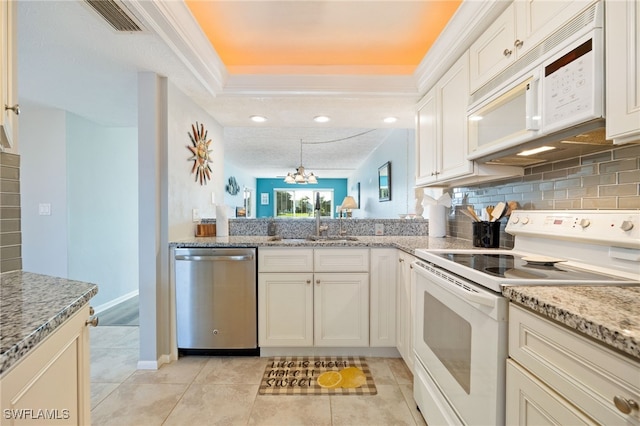 4549 SE 5th Pl Unit 109, Cape Coral, FL 33904 - kitchen with white appliances, light stone countertops, light tile patterned floors, a chandelier, and tasteful backsplash