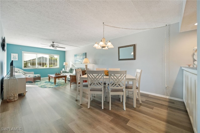 4549 SE 5th Pl Unit 109, Cape Coral, FL 33904 - dining area with wood finished floors, a textured ceiling, ceiling fan, and a chandelier