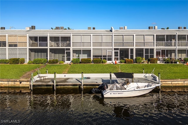 4549 SE 5th Pl Unit 109, Cape Coral, FL 33904 - dock with a water view and a lawn