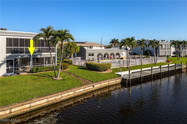 4549 SE 5th Pl Unit 109, Cape Coral, FL 33904 - dock with a water view and a lawn