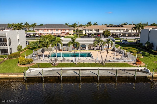 4549 SE 5th Pl Unit 109, Cape Coral, FL 33904 - rear view of house with a water view, a residential view, a patio area, and a community pool