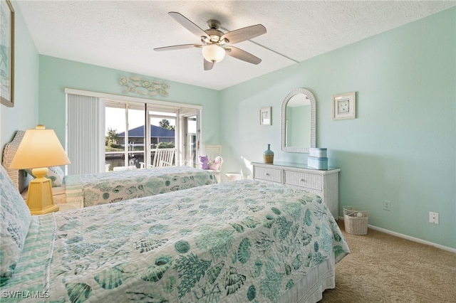 4549 SE 5th Pl Unit 109, Cape Coral, FL 33904 - bedroom with access to outside, carpet floors, a textured ceiling, and a ceiling fan