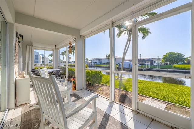 4549 SE 5th Pl Unit 109, Cape Coral, FL 33904 - unfurnished sunroom with a water view, a residential view, and outdoor dining area