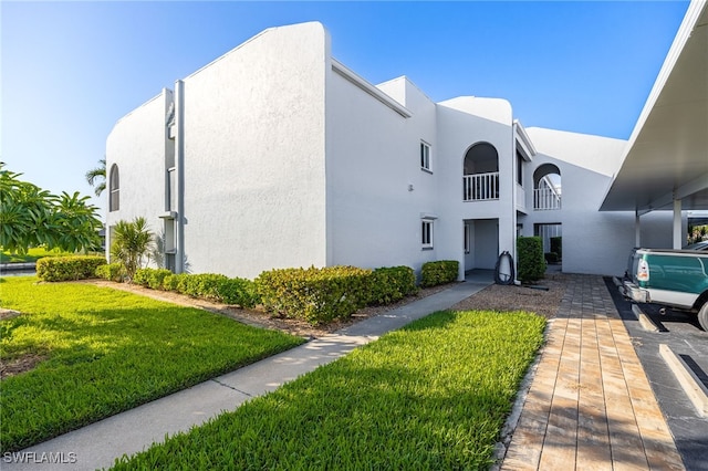 4549 SE 5th Pl Unit 109, Cape Coral, FL 33904 - view of front of home with stucco siding and a front yard