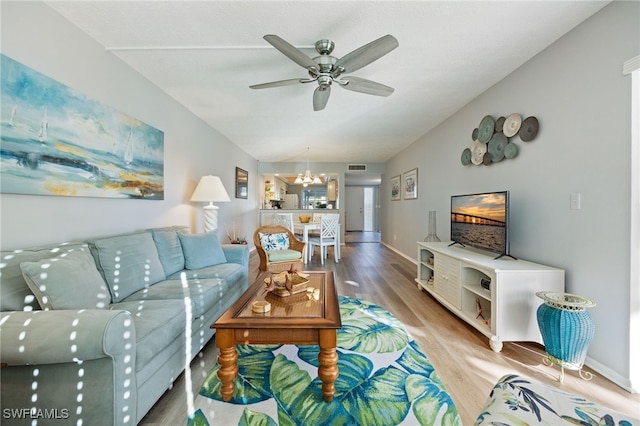 4549 SE 5th Pl Unit 109, Cape Coral, FL 33904 - living room featuring wood finished floors, ceiling fan, and a chandelier