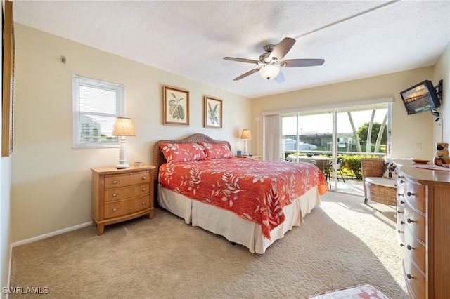 4549 SE 5th Pl Unit 109, Cape Coral, FL 33904 - bedroom with access to exterior, light colored carpet, ceiling fan, and a textured ceiling