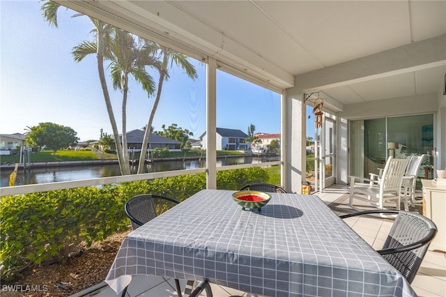 4549 SE 5th Pl Unit 109, Cape Coral, FL 33904 - sunroom / solarium with a water view, outdoor dining area, and a residential view