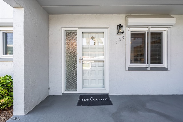 4549 SE 5th Pl Unit 109, Cape Coral, FL 33904 - doorway to property featuring stucco siding