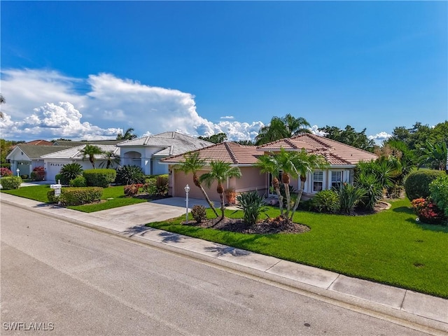 1670 Palo Duro Blvd, North Fort Myers, FL 33917 - view of front facade featuring concrete driveway, a garage, a front lawn, and a tile roof