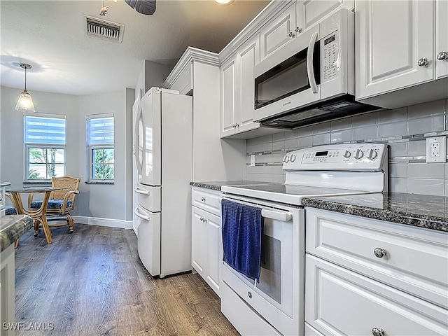 1670 Palo Duro Blvd, North Fort Myers, FL 33917 - kitchen featuring white appliances, white cabinets, tasteful backsplash, and wood finished floors