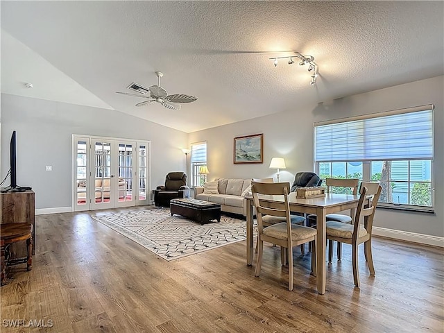 1670 Palo Duro Blvd, North Fort Myers, FL 33917 - dining space featuring healthy amount of natural light, a textured ceiling, ceiling fan, wood finished floors, and french doors