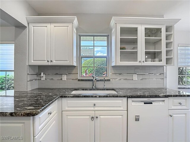 1670 Palo Duro Blvd, North Fort Myers, FL 33917 - kitchen featuring dishwasher, white cabinetry, tasteful backsplash, and glass insert cabinets
