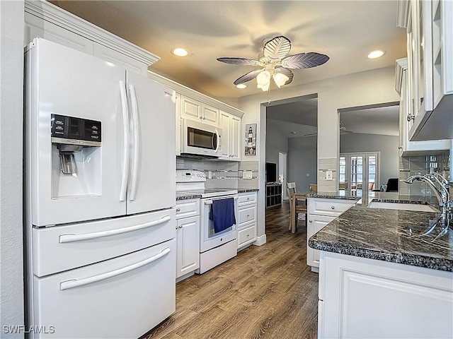 1670 Palo Duro Blvd, North Fort Myers, FL 33917 - kitchen with white appliances, a ceiling fan, decorative backsplash, dark wood-style floors, and recessed lighting