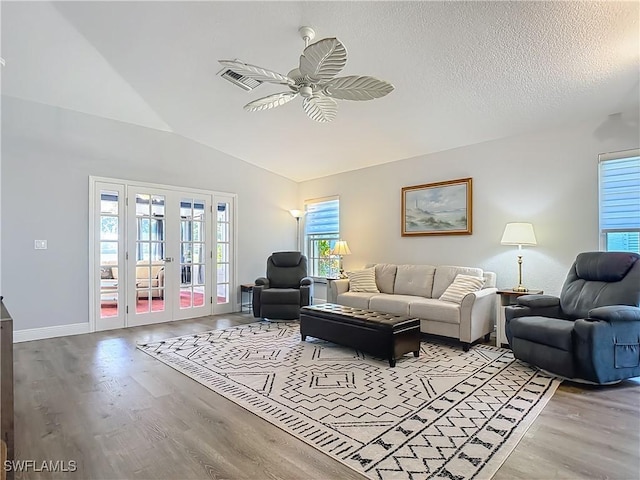 1670 Palo Duro Blvd, North Fort Myers, FL 33917 - living area featuring wood finished floors, a ceiling fan, lofted ceiling, and french doors