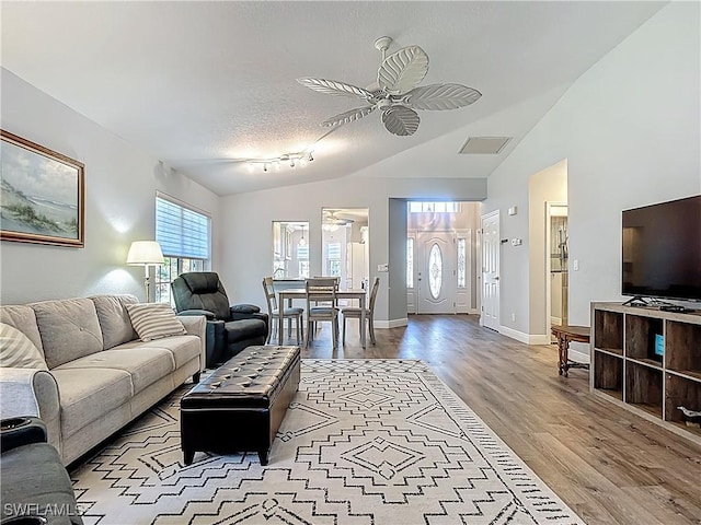 1670 Palo Duro Blvd, North Fort Myers, FL 33917 - living room featuring a ceiling fan, wood finished floors, lofted ceiling, and a textured ceiling