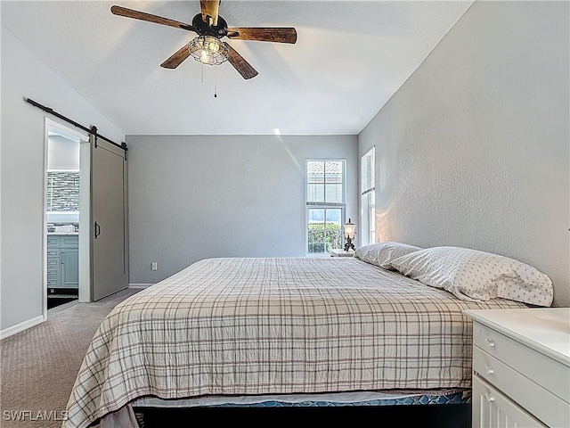 1670 Palo Duro Blvd, North Fort Myers, FL 33917 - bedroom featuring vaulted ceiling, light carpet, a barn door, a textured wall, and a ceiling fan