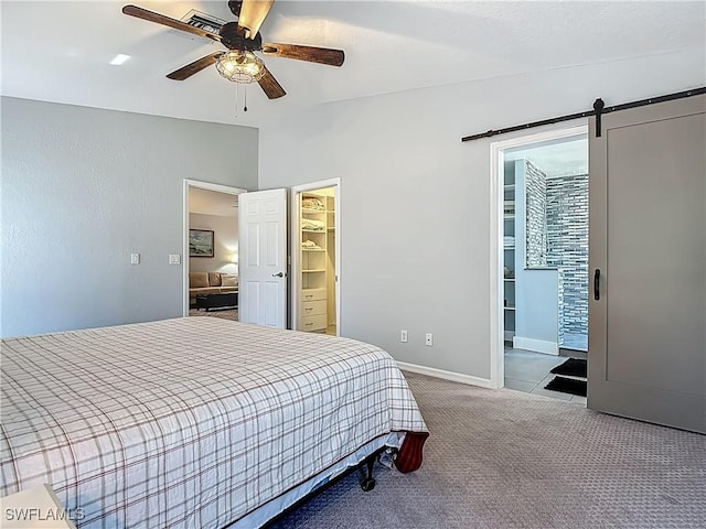 1670 Palo Duro Blvd, North Fort Myers, FL 33917 - bedroom featuring carpet flooring, a spacious closet, vaulted ceiling, a ceiling fan, and a barn door