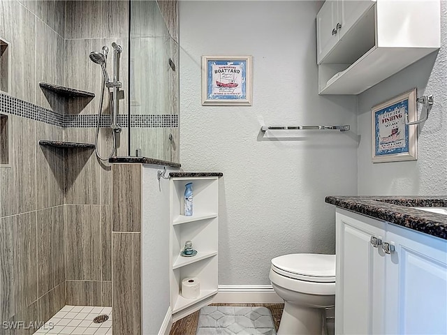 1670 Palo Duro Blvd, North Fort Myers, FL 33917 - bathroom featuring a tile shower, vanity, tile patterned flooring, and a textured wall