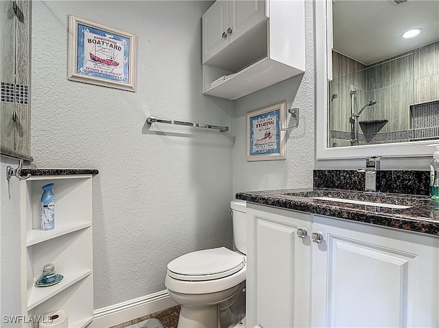 1670 Palo Duro Blvd, North Fort Myers, FL 33917 - bathroom featuring vanity, a textured wall, tiled shower, and wood finished floors