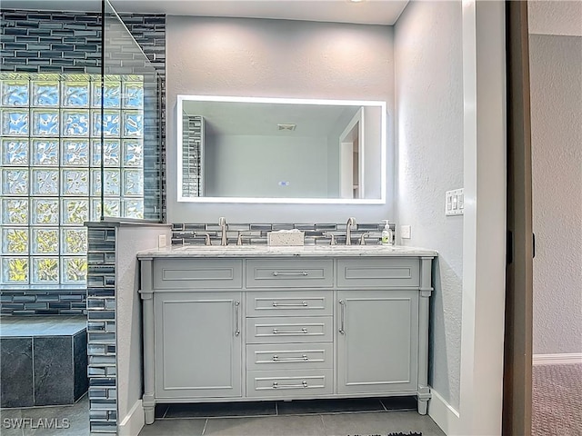 1670 Palo Duro Blvd, North Fort Myers, FL 33917 - bathroom with double vanity, tile patterned floors, and a textured wall
