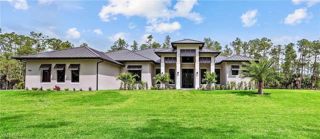 5174 Sycamore Dr, Naples, FL 34119 - prairie-style house with a standing seam roof, stucco siding, a metal roof, and a front yard