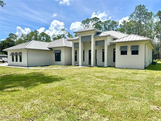 5174 Sycamore Dr, Naples, FL 34119 - rear view of house with a standing seam roof, stucco siding, and a metal roof