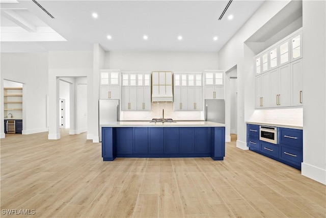 5174 Sycamore Dr, Naples, FL 34119 - kitchen with premium range hood, appliances with stainless steel finishes, backsplash, light countertops, and recessed lighting
