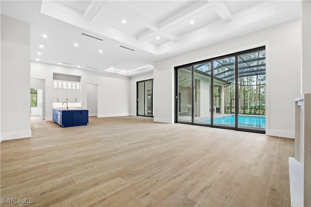 5174 Sycamore Dr, Naples, FL 34119 - unfurnished living room featuring coffered ceiling, light wood-style flooring, beam ceiling, recessed lighting, and a towering ceiling