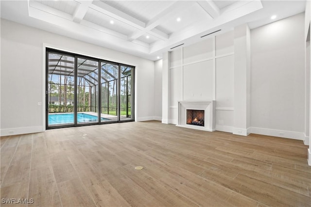 5174 Sycamore Dr, Naples, FL 34119 - unfurnished living room with light wood-style floors, coffered ceiling, beam ceiling, recessed lighting, and a warm lit fireplace