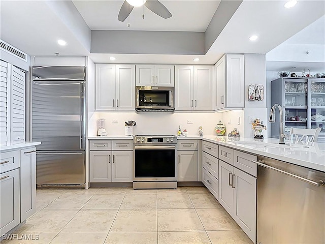 3000 Oasis Grand Blvd Unit 1203, Fort Myers, FL 33916 - kitchen with stainless steel appliances, ceiling fan, light countertops, light tile patterned floors, and recessed lighting