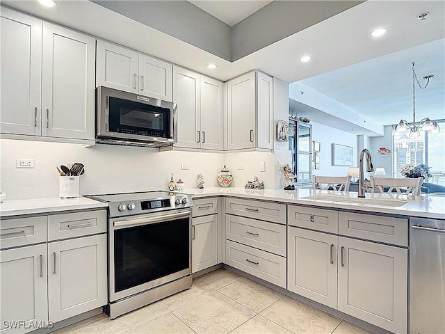 3000 Oasis Grand Blvd Unit 1203, Fort Myers, FL 33916 - kitchen featuring appliances with stainless steel finishes, light countertops, gray cabinets, light tile patterned flooring, and recessed lighting
