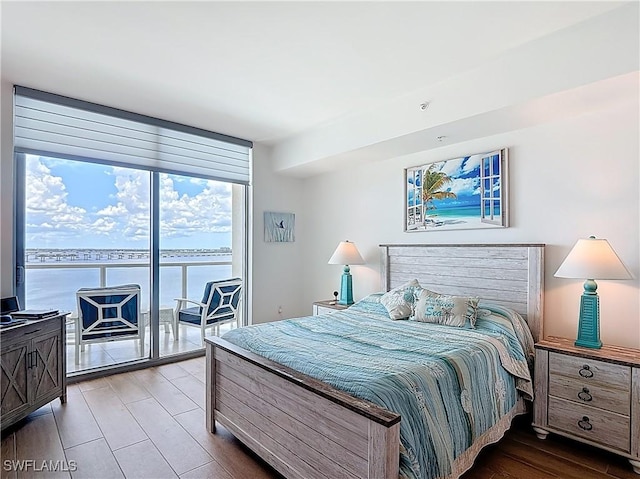 3000 Oasis Grand Blvd Unit 1203, Fort Myers, FL 33916 - bedroom with access to exterior, expansive windows, and wood finished floors