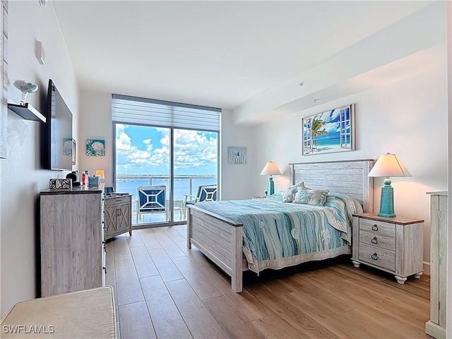 3000 Oasis Grand Blvd Unit 1203, Fort Myers, FL 33916 - bedroom with access to outside, light wood-type flooring, and a wall of windows