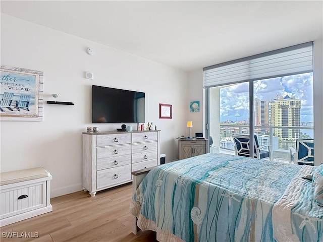 3000 Oasis Grand Blvd Unit 1203, Fort Myers, FL 33916 - bedroom with access to outside and light wood-type flooring