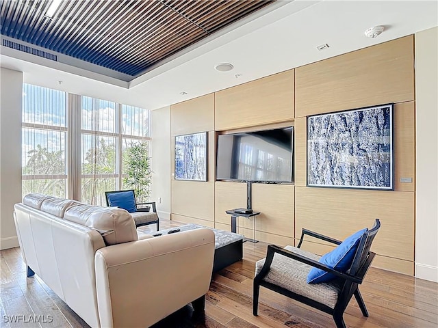 3000 Oasis Grand Blvd Unit 1203, Fort Myers, FL 33916 - living room featuring light wood finished floors and a tray ceiling