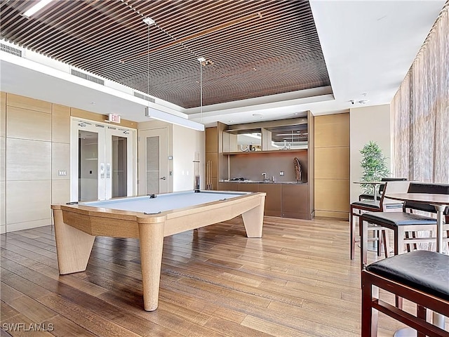 3000 Oasis Grand Blvd Unit 1203, Fort Myers, FL 33916 - rec room with light wood finished floors, a raised ceiling, pool table, and french doors