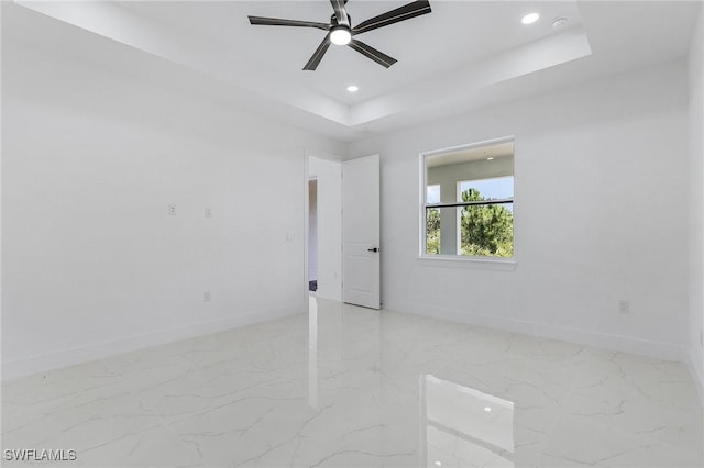 3805 E 16th St, Lehigh Acres, FL 33972 - empty room with light marble finish floors, a tray ceiling, ceiling fan, and recessed lighting