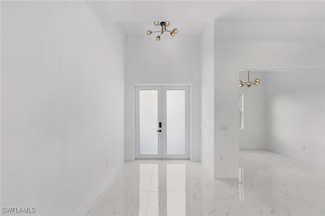 3805 E 16th St, Lehigh Acres, FL 33972 - entrance foyer with marble tiled flooring, a chandelier, and french doors