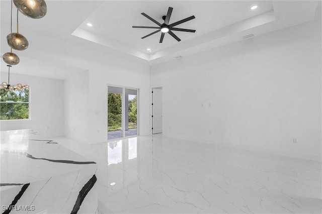 3805 E 16th St, Lehigh Acres, FL 33972 - empty room with marble tiled flooring, plenty of natural light, a raised ceiling, recessed lighting, and a ceiling fan