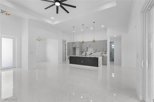 3805 E 16th St, Lehigh Acres, FL 33972 - unfurnished living room featuring ceiling fan, recessed lighting, light marble finish floors, and a towering ceiling