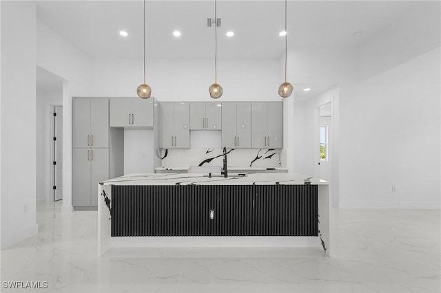 3805 E 16th St, Lehigh Acres, FL 33972 - kitchen featuring light marble finish floors, a large island, gray cabinetry, recessed lighting, and light countertops