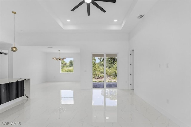 3805 E 16th St, Lehigh Acres, FL 33972 - unfurnished living room featuring a ceiling fan, marble tiled floors, a chandelier, recessed lighting, and a tray ceiling