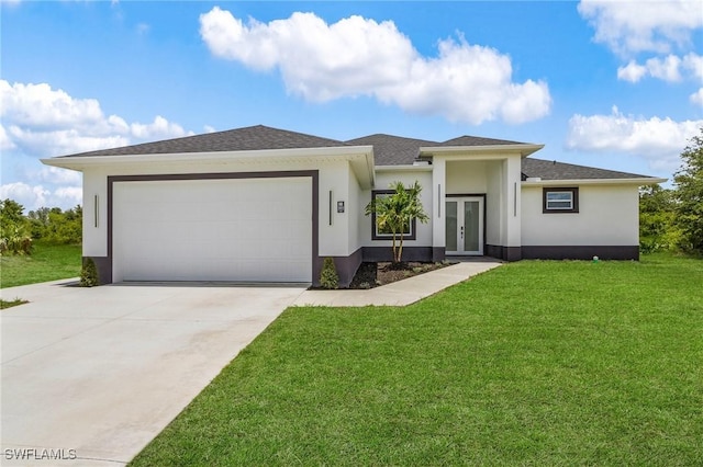 3805 E 16th St, Lehigh Acres, FL 33972 - prairie-style home featuring french doors, stucco siding, an attached garage, driveway, and a front lawn