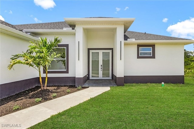 3805 E 16th St, Lehigh Acres, FL 33972 - property entrance with stucco siding, a lawn, roof with shingles, and french doors