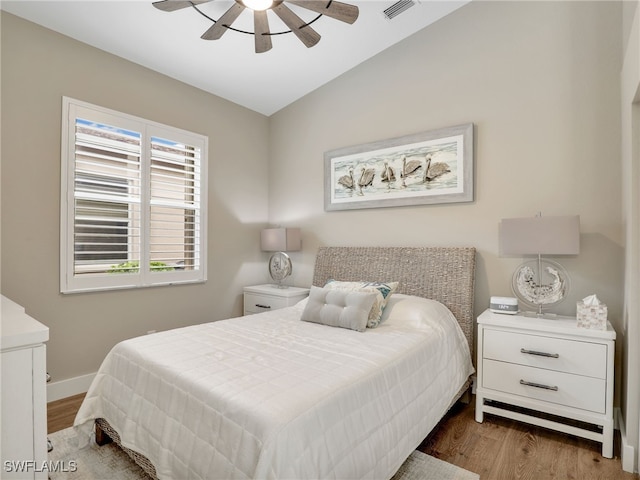 8612 Ibis Cove Cir, Naples, FL 34119 - bedroom with wood finished floors, lofted ceiling, and a ceiling fan