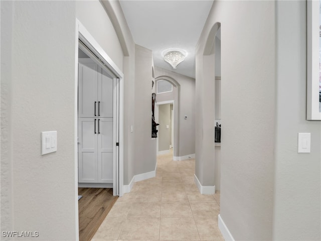 8612 Ibis Cove Cir, Naples, FL 34119 - hall featuring arched walkways and light tile patterned floors
