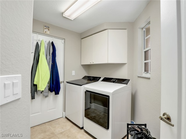 8612 Ibis Cove Cir, Naples, FL 34119 - laundry area featuring washer and clothes dryer, cabinet space, and light tile patterned floors