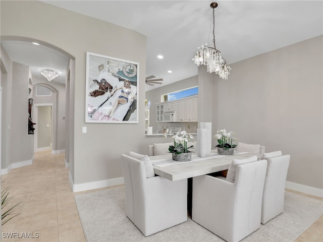 8612 Ibis Cove Cir, Naples, FL 34119 - dining space with arched walkways, a chandelier, recessed lighting, light tile patterned floors, and a ceiling fan